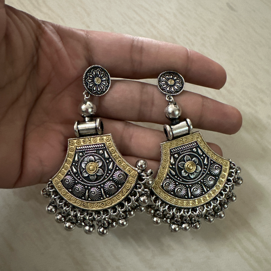 Oxidised silver earrings with floral design, golden detailing, and hanging ghungroos.
