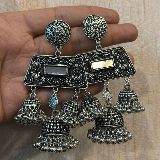 Oxidised silver jhumka earrings with intricate design and multiple hangings.