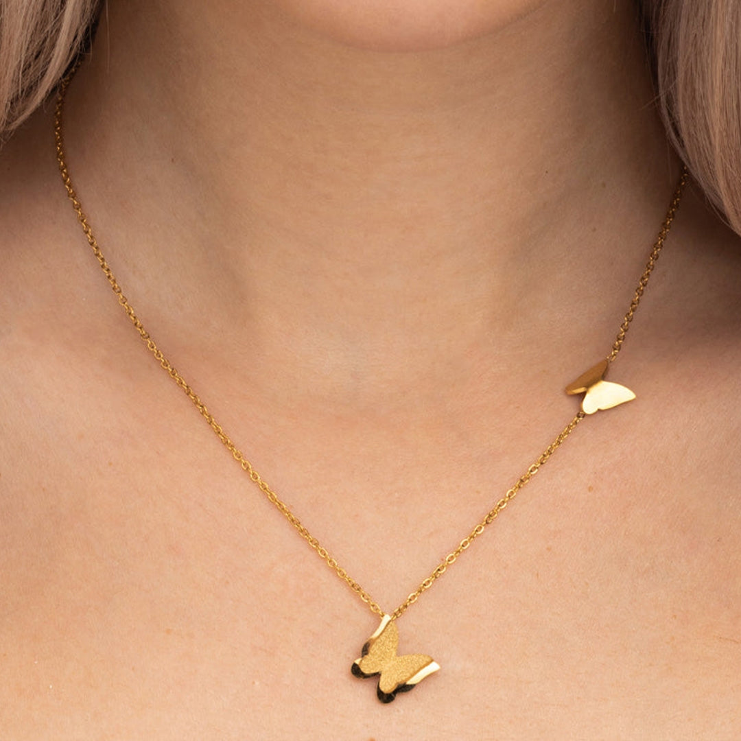 Gold-tone necklace features twin butterfly charms
