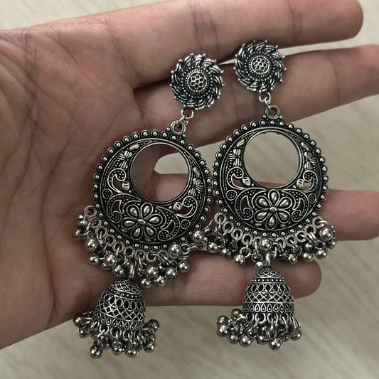 oxidized silver earrings with floral motifs, circular cut-outs, and traditional jhumka drops