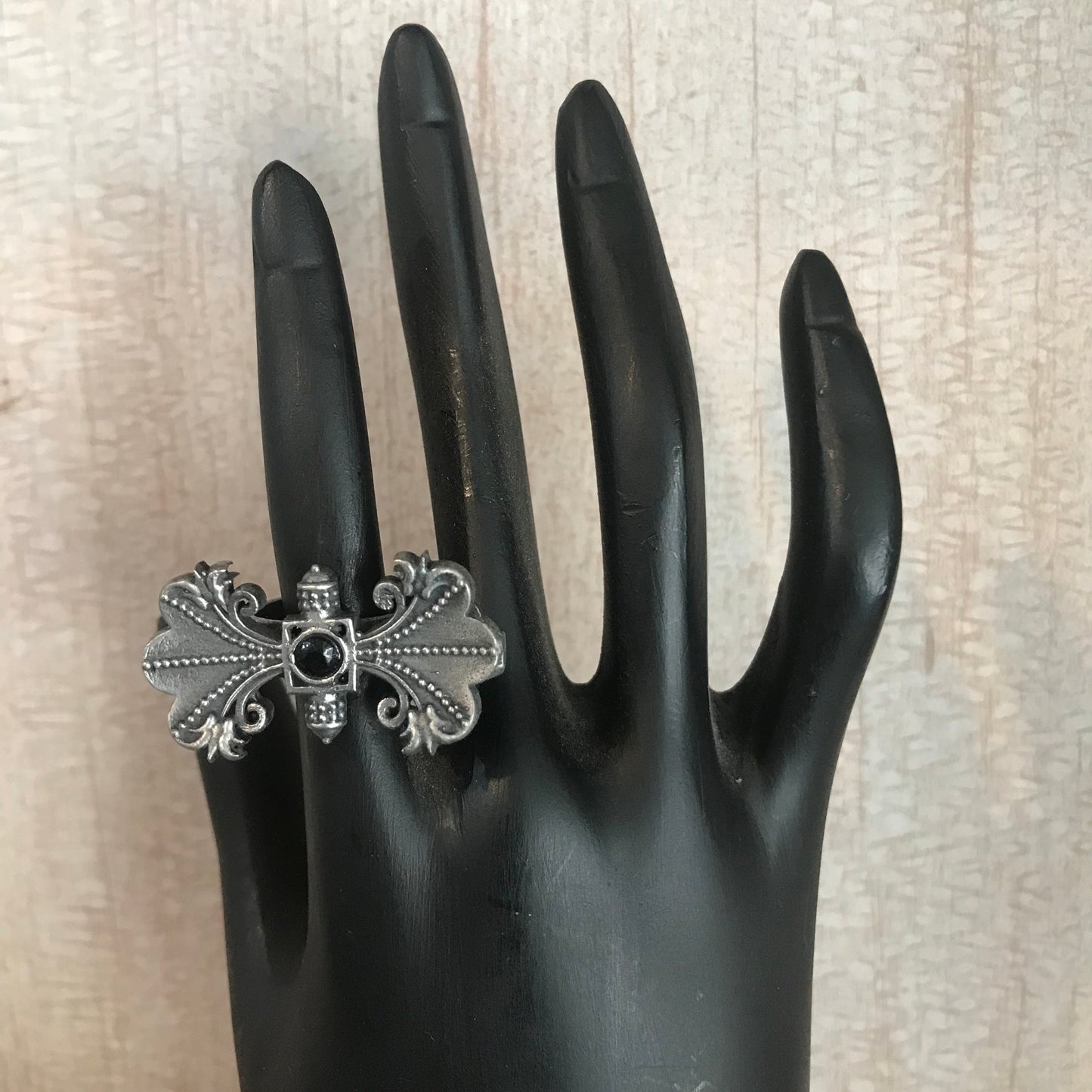 oxidized silver ring with an ornate vintage design.