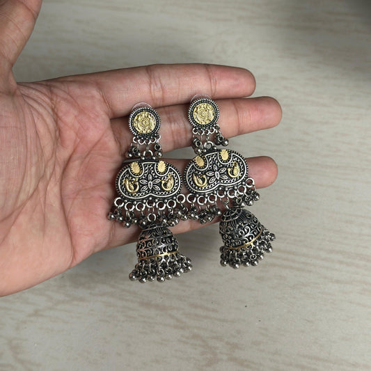 Oxidised silver jhumka earrings with golden coin detailing and hanging ghungroos.