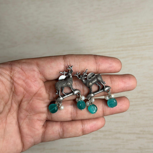 Oxidized deer motif earrings with teal and pearl bead danglers.
