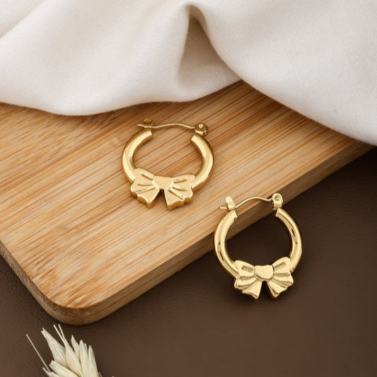 Gold hoop earrings with bow