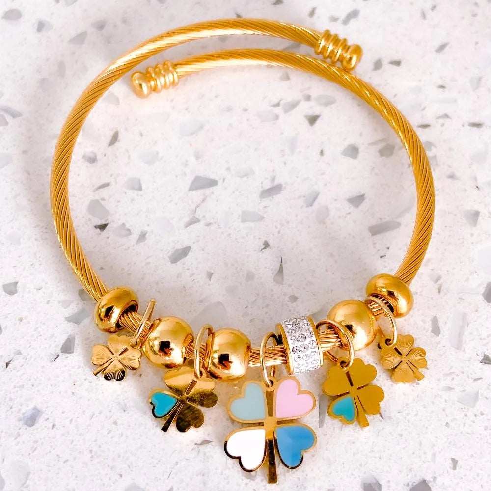 Gold-toned twist-cuff charm bracelets.